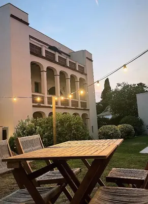 a wooden picnic table in front of a building at Hotel Palou 1874 in Sant Pere de Ribes