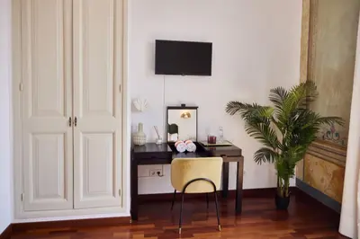 a room with a desk with a chair and a mirror at Hotel Palou 1874 in Sant Pere de Ribes