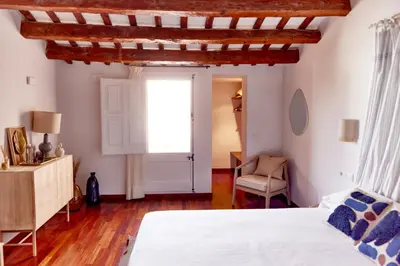a bedroom with a bed and a window at Hotel Palou 1874 in Sant Pere de Ribes