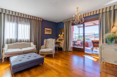 a living room with a couch and a table at Hotel Blancafort Spa Termal in La Garriga