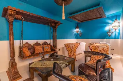 a room with a mirror and a table and chairs at Hotel Blancafort Spa Termal in La Garriga