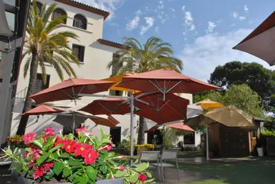 a group of umbrellas in front of a building at Hotel El Castell in Sant Boi del Llobregat