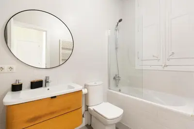a bathroom with a toilet and a sink and a mirror at Señor Urgell Apartment by Olala Homes in Barcelona