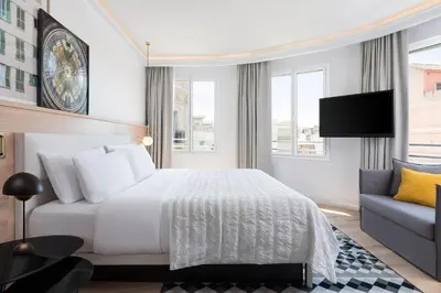 a hotel room with a bed and a couch at Le Meridien Barcelona in Barcelona