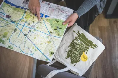 a person holding a map and a bag at Hostal Marenostrum in Barcelona
