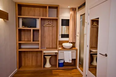 a bathroom with a sink and a television at Hostal Marenostrum in Barcelona