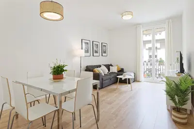 a dining room and living room with a table and chairs at CENTRAL & BRIGHT APARTMENT!! in Barcelona