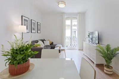 a white living room with a couch and a table at CENTRAL & BRIGHT APARTMENT!! in Barcelona