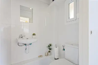 a white bathroom with a sink and a toilet at CENTRAL & BRIGHT APARTMENT!! in Barcelona