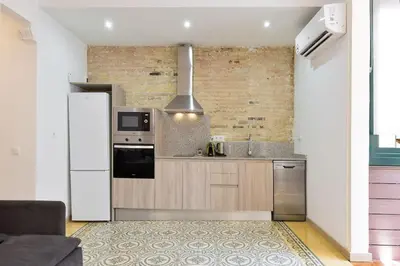 a kitchen with a white refrigerator and a stove at Bright Apt with Private Terrace in Sant Antoni in Barcelona
