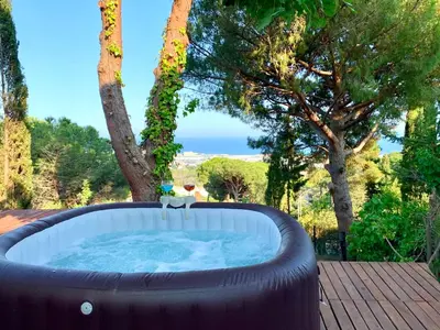 a large hot tub sitting on a deck with trees at Les Terrasses de la Cisa, 20kms de BCN in Premia de Dalt