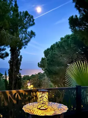 a table on a balcony with a view of the ocean at Les Terrasses de la Cisa, 20kms de BCN in Premia de Dalt