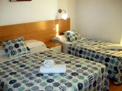 a hotel room with two beds with a towel on it at Hostal Felipe 2 in Barcelona
