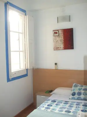 a bedroom with a bed and a window at Hostal Felipe 2 in Barcelona