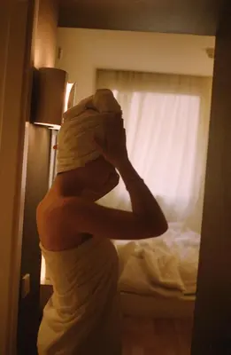 a woman standing in front of a mirror at Pol & Grace Hotel in Barcelona