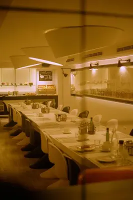 a long row of tables in a restaurant at Pol & Grace Hotel in Barcelona