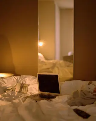 a laptop computer sitting on top of a bed at Pol & Grace Hotel in Barcelona