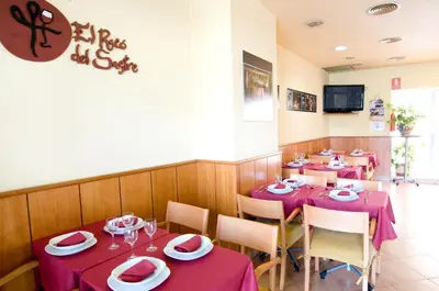 a dining room with tables with purple tablecloths at Hotel Ciutat De Sant Adria in Sant Adria de Besos