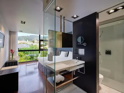 a bathroom with a sink and a glass wall at Ikonik Anglí in Barcelona
