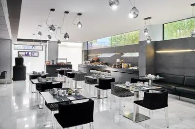 a restaurant with tables and chairs and a bar at Ikonik Anglí in Barcelona