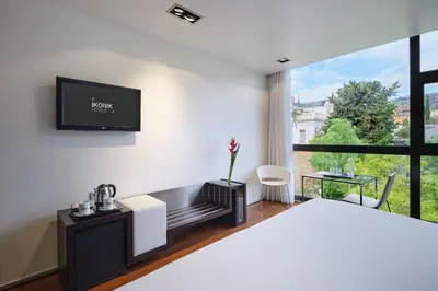a bedroom with a bed and a tv on a wall at Ikonik Anglí in Barcelona
