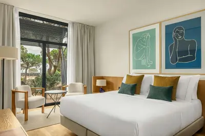 a bedroom with a large white bed and a large window at Sabàtic Gavà Mar, Barcelona, a Tribute Portfolio Hotel in Gavà