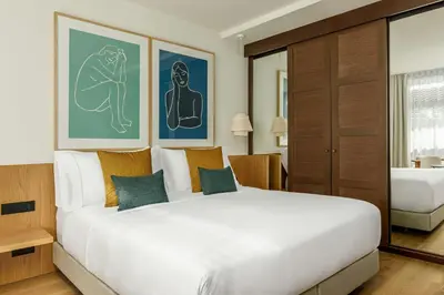 a bedroom with a large white bed in a room at Sabàtic Gavà Mar, Barcelona, a Tribute Portfolio Hotel in Gavà