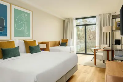 a hotel room with a large bed and a desk at Sabàtic Gavà Mar, Barcelona, a Tribute Portfolio Hotel in Gavà