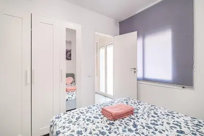 a bedroom with a bed with a bag on it at Magic Badalona House in Badalona