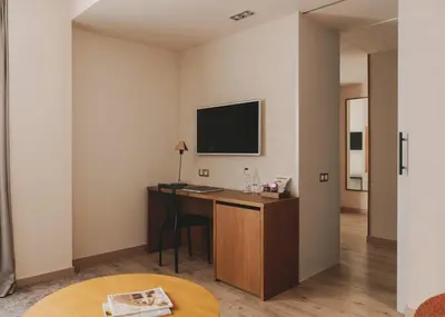 a hotel room with a desk and a tv at Catalonia Boulevard in Barcelona