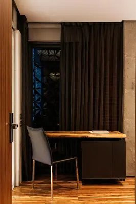 a desk and a chair in front of a window at Hotel Granados 83, a member of Preferred Hotels & Resorts in Barcelona