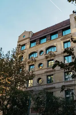 a building with a clock on the side of it at Hotel Granados 83, a member of Preferred Hotels & Resorts in Barcelona