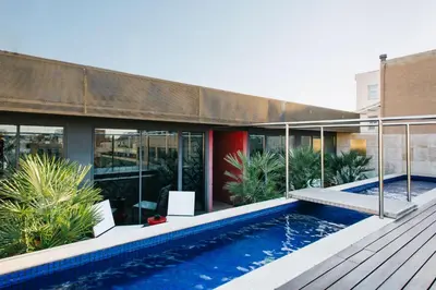 a house with a swimming pool next to a building at Hotel Granados 83, a member of Preferred Hotels & Resorts in Barcelona