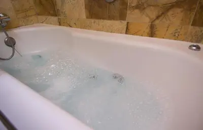 a bath tub filled with water in a bathroom at Flor Parks in Barcelona