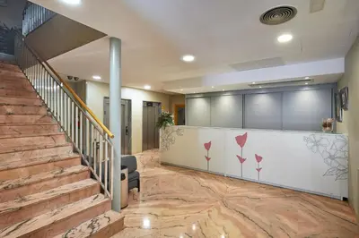 a lobby with a staircase and a waiting room at Flor Parks in Barcelona