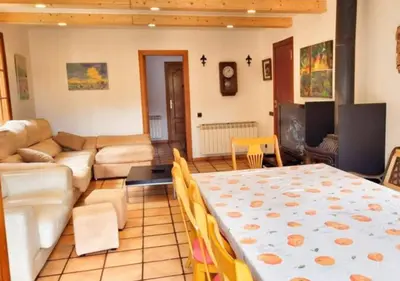a living room with a table and a couch at Casa Donaire in Marganell