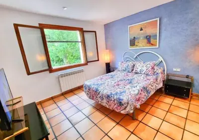 a bedroom with a bed and a window at Casa Donaire in Marganell