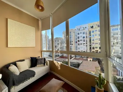 a living room with a couch and a large window at The Collection Barcelona - Sagrada Familia 4BD only for Families or Business groups in Barcelona