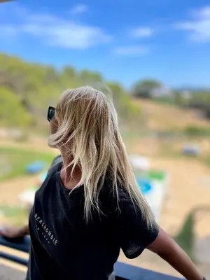 a woman with long blonde hair looking out a window at VILLA CHETRUS Casa en plena naturaleza in Rubí