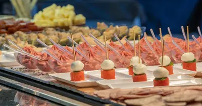 a buffet of food with appetizers and meats on plates at Montanyà in Seva