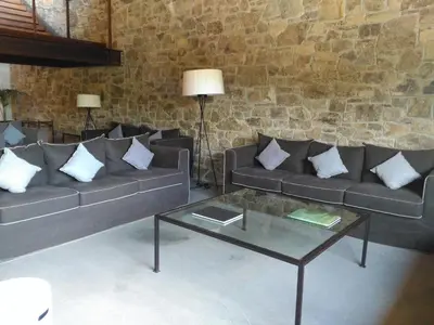 a living room with two couches and a glass table at Montanyà in Seva