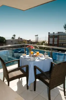 a table on a balcony with a table and chairs at Best Western Hotel Mediterraneo in Castelldefels