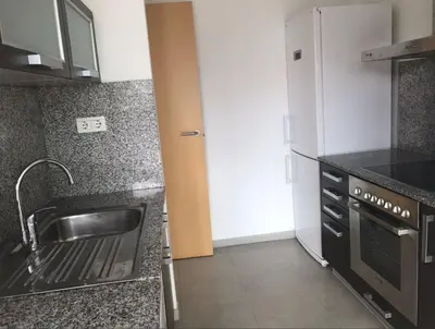 a kitchen with a sink and a refrigerator at Beach & Culture Barcelona Port Forum Penthouse Apartment in Sant Adria de Besos