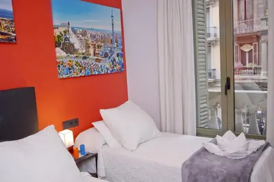 a hotel room with a bed and a window at Barcelona City Centre Hostal in Barcelona