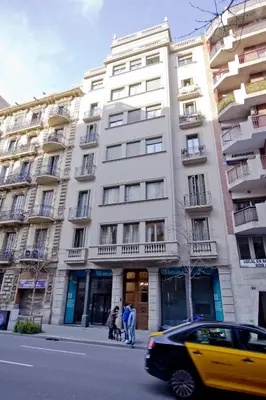 a large white building with people standing in front of it at Barcelona City Centre Hostal in Barcelona