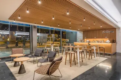a restaurant with tables and chairs in a building at Occidental Atenea Mar - Adults Only in Barcelona