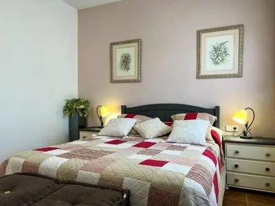 a bedroom with a bed with a quilt on it at Vivalidays Casa Ricardo in Sant Cebrià de Vallalta