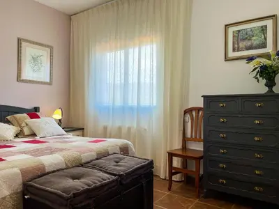 a bedroom with a bed and a dresser and a window at Vivalidays Casa Ricardo in Sant Cebrià de Vallalta