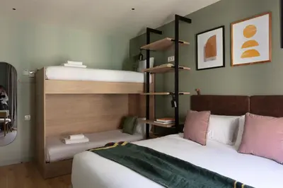 two beds in a room with two bunk beds at TOC Hotel Las Ramblas in Barcelona