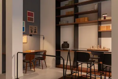 a room with chairs and a table and shelves at TOC Hotel Las Ramblas in Barcelona